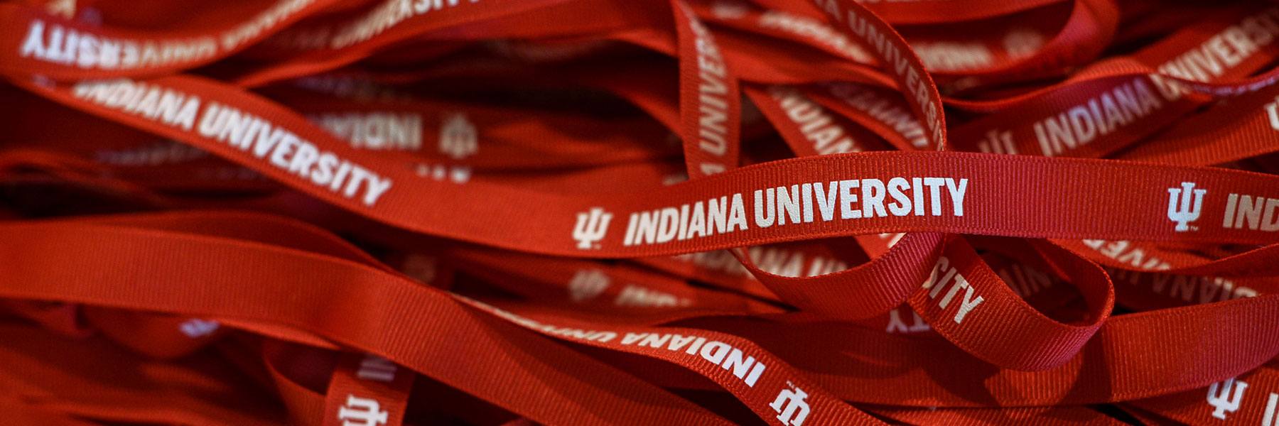 A pile of red lanyards with Indiana University printed on them