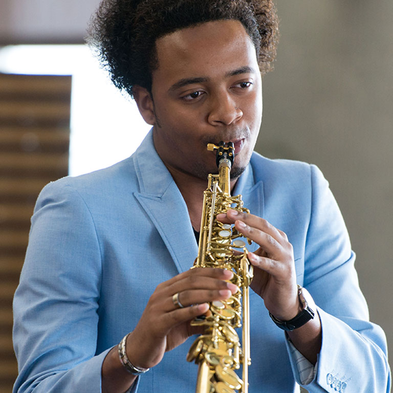 Musician playing a saxophone.