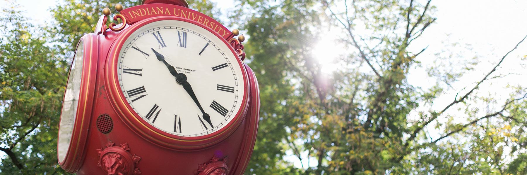 A closeup of a red outdoor clock on the IU Bloomington campus