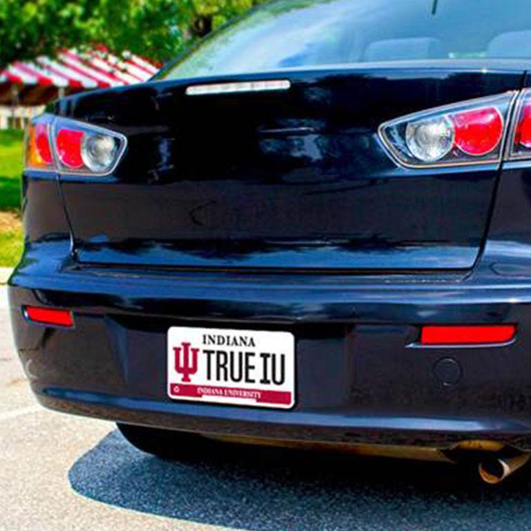 The back of a black car with an IU Alumni license plate that reads TRUEIU